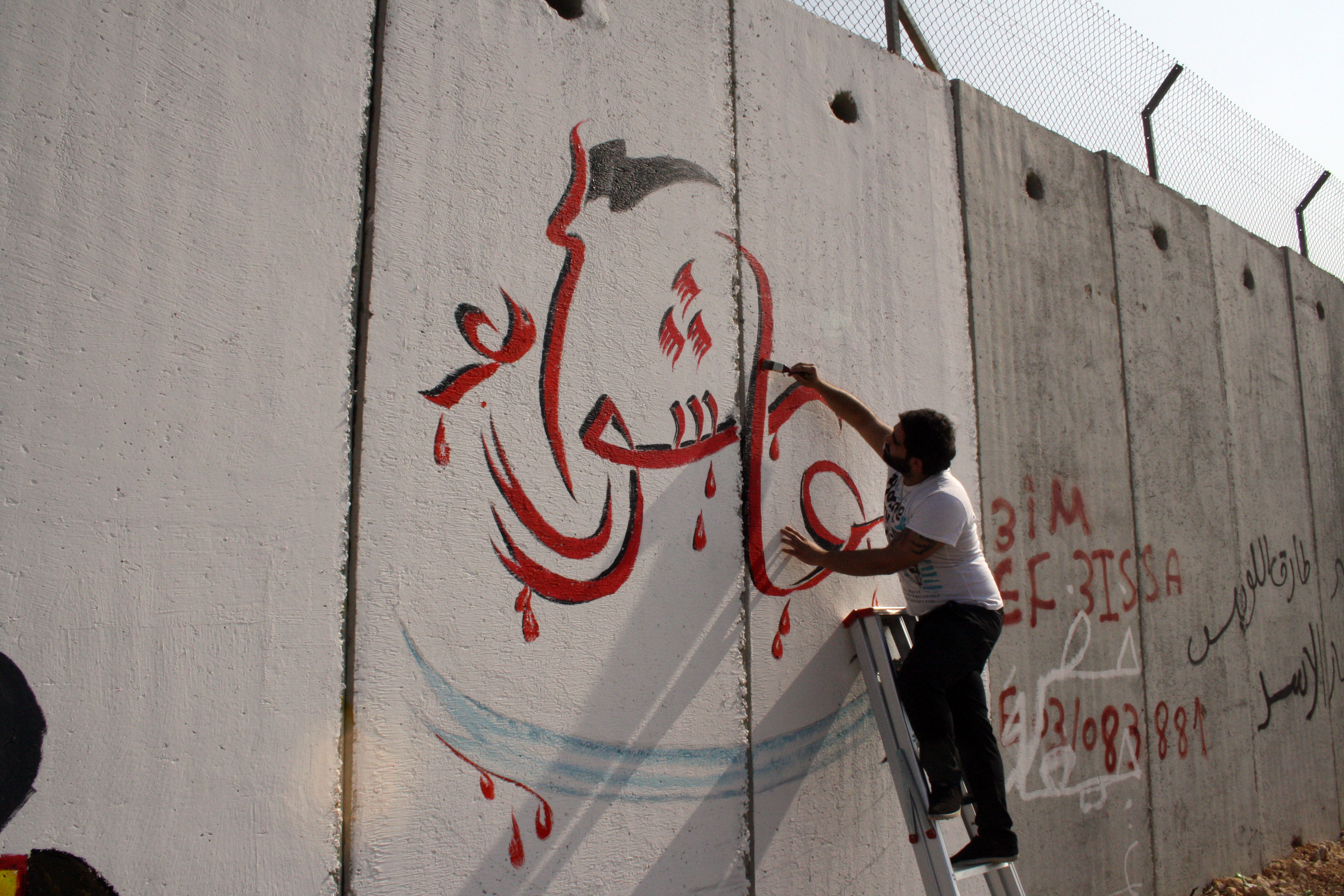 رسومات لمدرسة عيسى بن مريم على الجدار الفاصل  من وحي عاشوراء