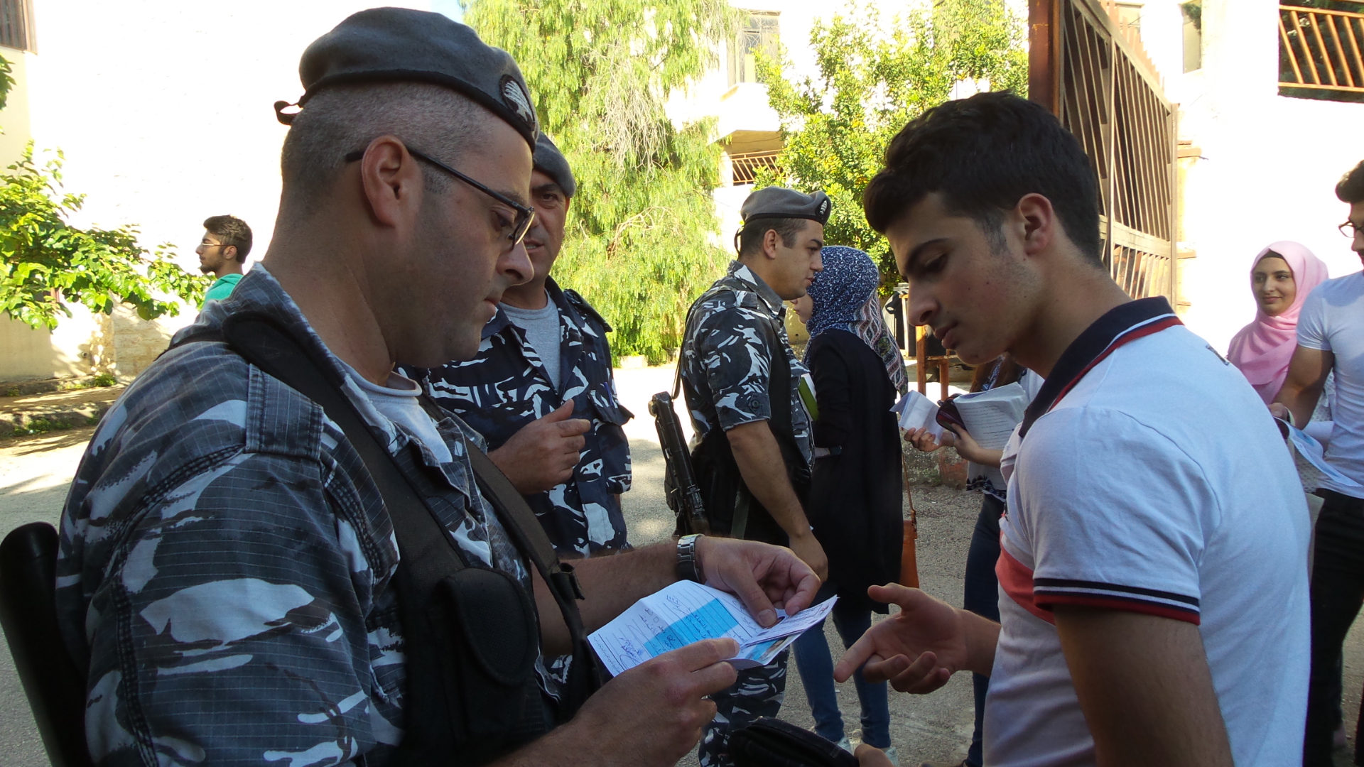 عنصر من الدرك يفتش طالبا قبل دخوله مكان الامتحان