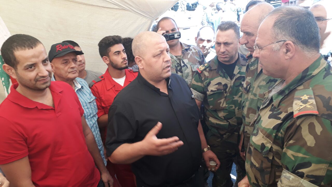 كاهن الرعية الراعي في حديث مع احد الضباط