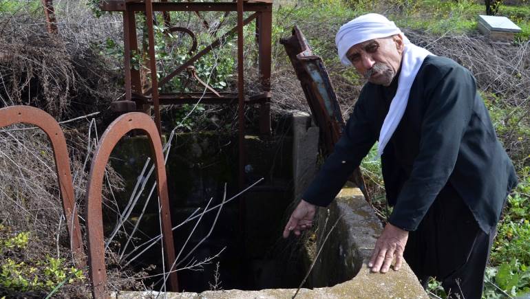 أبو عادل يشير الى مدخل المنجم (زياد الشوفي)